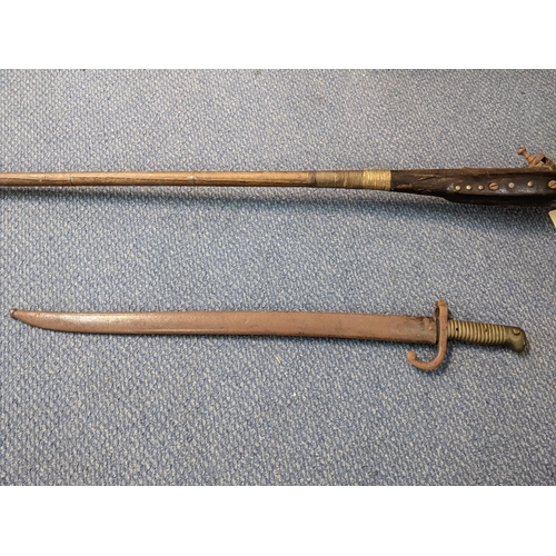 36 - A 19th century reproduction flintlock musket, along with a 19th century bayonet Location: LWF
If the... 