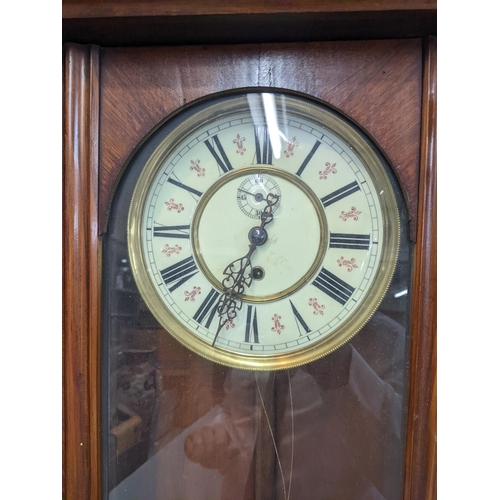 39 - A 20th century cased wall clock with carved column edges and a ceramic Roman dial Location: A2M
If t... 