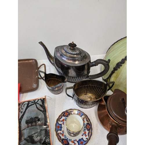 43 - A mixed lot to include a silver plated teapot, milk jug and sugar bowl, a twin handled rectangular c... 