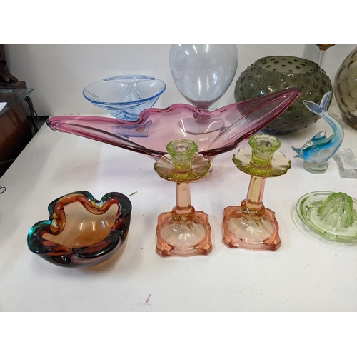 50 - A collection of 20th century art glass to include a pair of Uranium glass topped candlesticks, an or... 