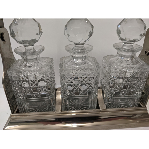 52 - A silver plated tantalus with three crystal cut glass decanters, a key
Location: 1.5
If there is no ... 