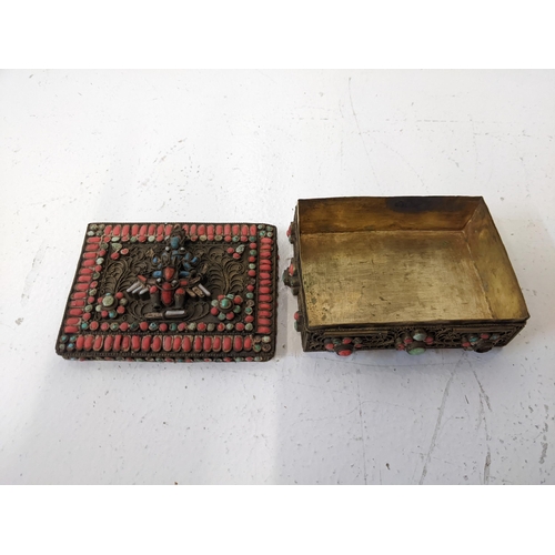 56 - An Indian brass box set with coral coloured cabochons and two goddesses
Location: 1.3
If there is no... 