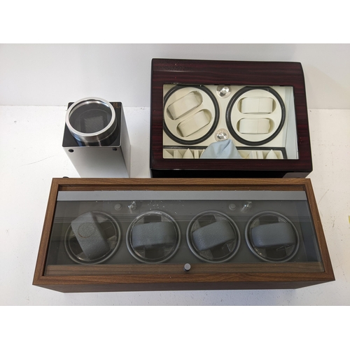 62 - Three watch display cases to include a wooden example with a glass hinged lid, another example with ... 