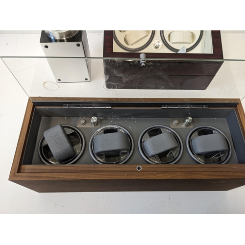 62 - Three watch display cases to include a wooden example with a glass hinged lid, another example with ... 