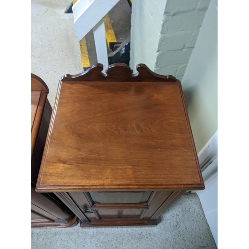 67 - A late Victorian walnut bedside cabinet with a panelled door and similar Edwardian example
Location:... 