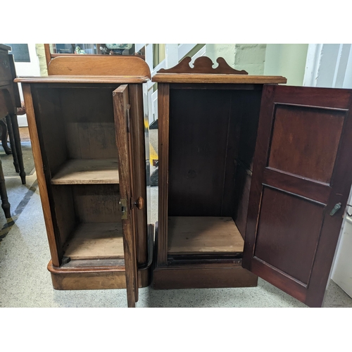 67 - A late Victorian walnut bedside cabinet with a panelled door and similar Edwardian example
Location:... 