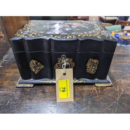 79 - A Victorian papier mache lidded tea caddy revealing a double lidded compartment, decorated with flor... 