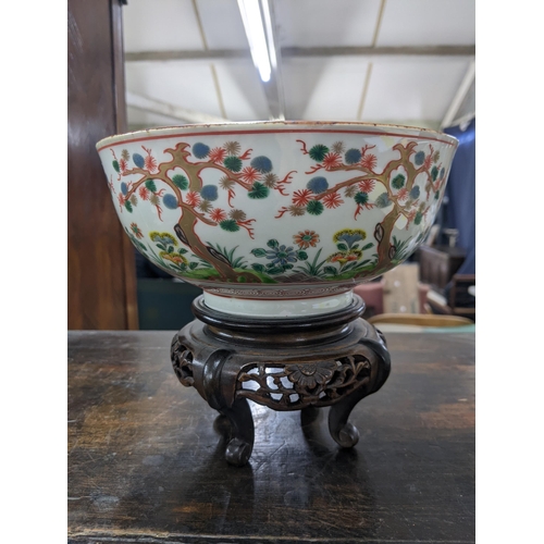 80 - A Japanese bowl and stand from the Meiji period decorated with Oriental plants and trees, 19cm dia, ... 