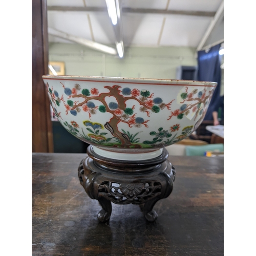 80 - A Japanese bowl and stand from the Meiji period decorated with Oriental plants and trees, 19cm dia, ... 