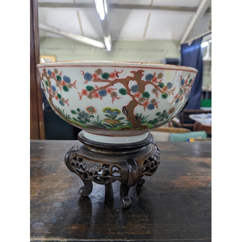 80 - A Japanese bowl and stand from the Meiji period decorated with Oriental plants and trees, 19cm dia, ... 