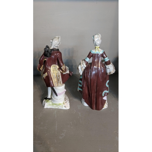 9 - A pair of 19th century porcelain figures of a lady and gentleman having Augustus Rex marks to the ba... 