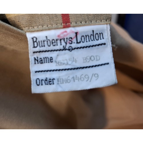 7 - Burberrys- A late 20th Century gents beige Kensington trench coat with bone effect buttons, double b... 