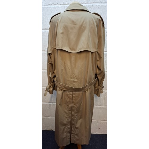 7 - Burberrys- A late 20th Century gents beige Kensington trench coat with bone effect buttons, double b... 