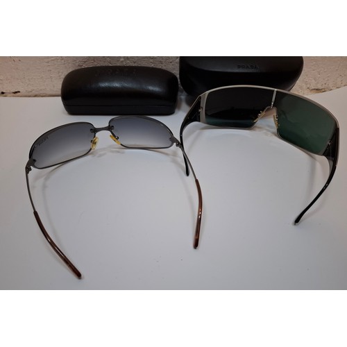 11 - Prada- 2 pairs of sunglasses, serial numbers 1AP-301 and 5AV-701 with black branded cases. Location:... 