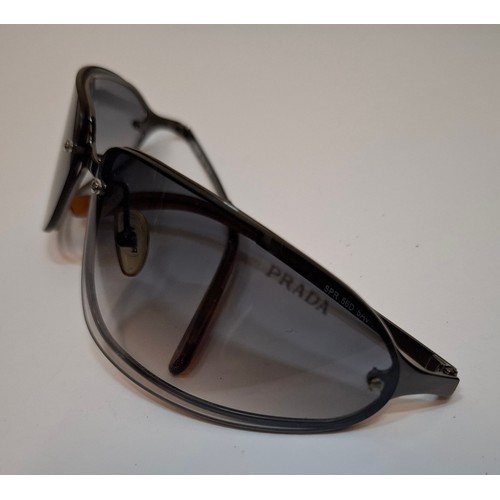 11 - Prada- 2 pairs of sunglasses, serial numbers 1AP-301 and 5AV-701 with black branded cases. Location:... 