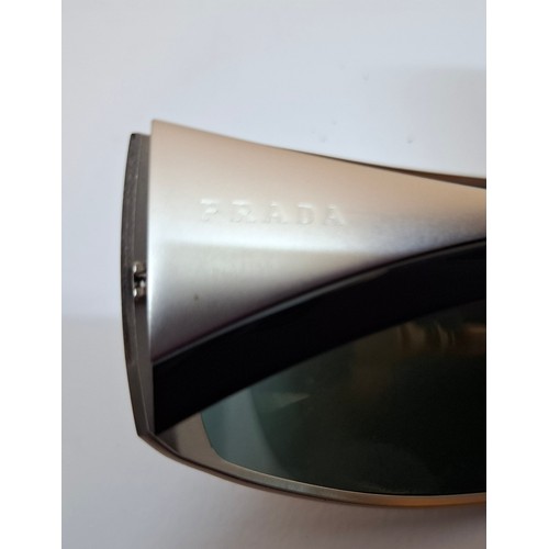 11 - Prada- 2 pairs of sunglasses, serial numbers 1AP-301 and 5AV-701 with black branded cases. Location:... 