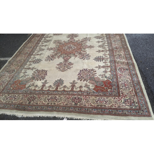 581 - A handwoven Persian Tabriz floral pattern rung with central motif on cream ground, triple guard bord... 