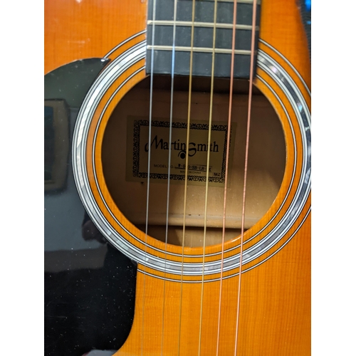 406 - A Martin Smith acoustic guitar in its original case, model no. W-500-SB-LH-PK Location: RWM
If there... 