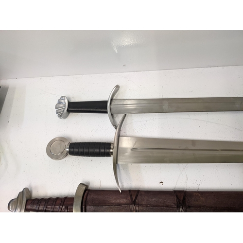 407 - Four reproduction blunt Saxon style swords, two with sheaths Location: A3M
If there is no condition ... 