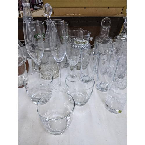 576 - A collection of glassware to include crystal cut decanters, wine glasses, a collection of blue art g... 