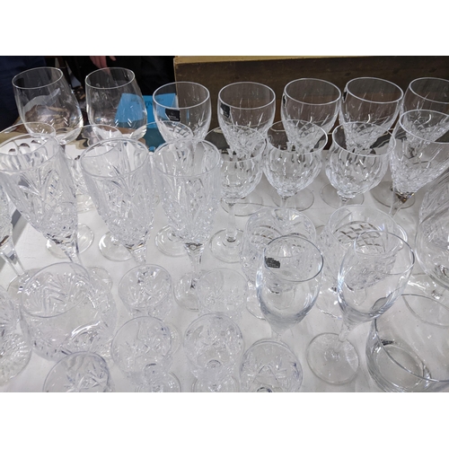 576 - A collection of glassware to include crystal cut decanters, wine glasses, a collection of blue art g... 