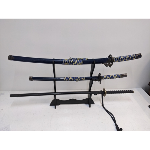 577 - Three blunt Samurai swords to include two with blue sheaths, and another with a black sheath Locatio... 