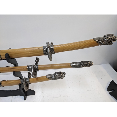 578 - Three blunt Samurai swords, all with caned sheaths with ends fashioned as dragons Location: GM
If th... 