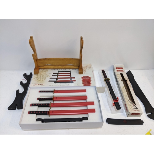 579 - A Samurai novelty kitchen knife set with original box, along with a boxed Samurai style chef's knife... 