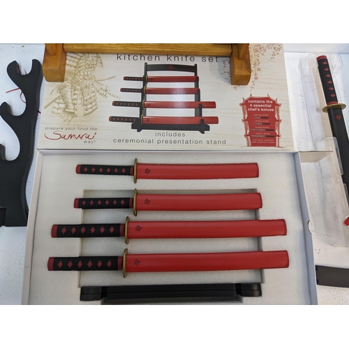 579 - A Samurai novelty kitchen knife set with original box, along with a boxed Samurai style chef's knife... 