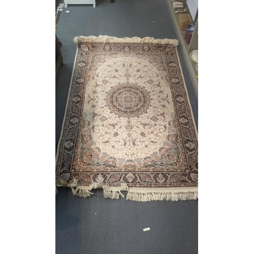 580 - A modern Persian machine woven rug having a floral design on cream ground with tasselled ends, 245cm... 