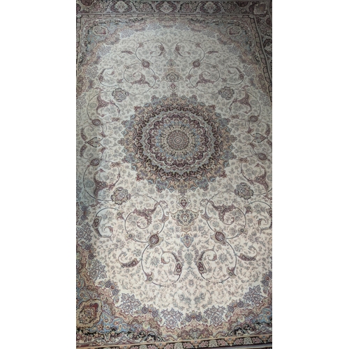 580 - A modern Persian machine woven rug having a floral design on cream ground with tasselled ends, 245cm... 