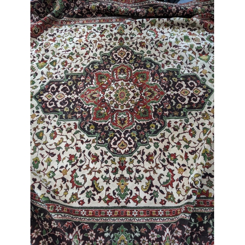 584 - A large machine woven Persian style rug, central medallion surrounded by floral all over decoration ... 