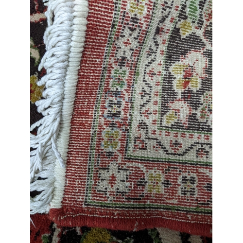 584 - A large machine woven Persian style rug, central medallion surrounded by floral all over decoration ... 