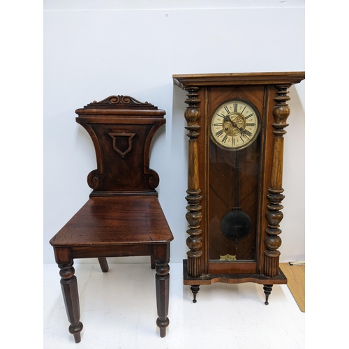 591 - A Victorian mahogany hall chair with an ornately carved back, and a walnut and beech late 19th centu... 