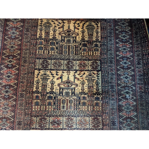 597 - Two Persian rugs to include one with a symmetrical repeating design on a dark blue background and an... 