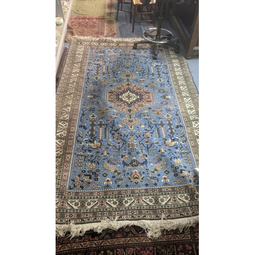 599 - A hand woven Persian rug with central medallion, geometric design and repeating motifs, tasselled en... 