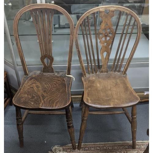 594 - Two early 20th century oak hoop back chairs on wheel back example, the other stamped F.H to the rear... 