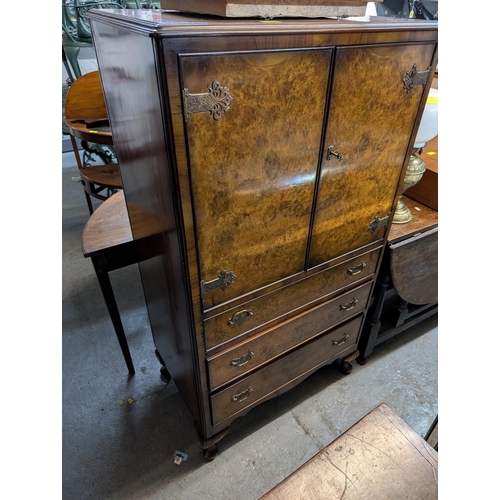 46 - A mid 20th century walnut cabinet with two doors, over three drawers, on cabriole feet, 137cm x 76cm... 