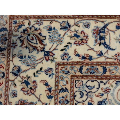 47 - A central Persian rug with a central medallion and entwined vines, on a blue and cream ground, 152cm... 