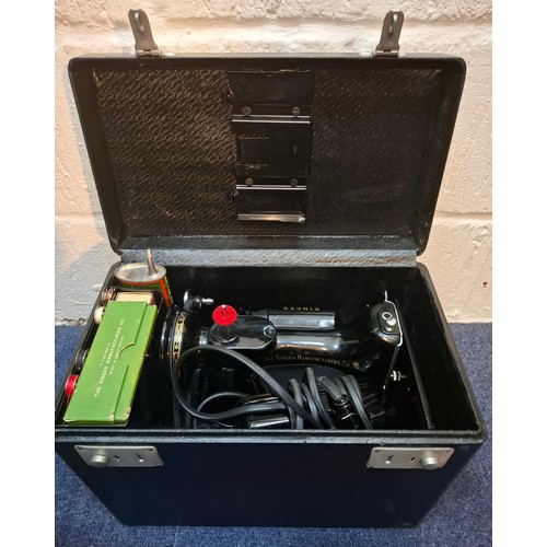 28 - A 1950's Singer 221K electric sewing machine in original fitted case with accessories and manual, se... 