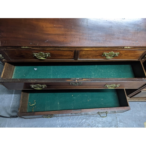 208 - An Georgian mahogany bureau with a fall flap revealing an interior racking and drawers, with two sho... 