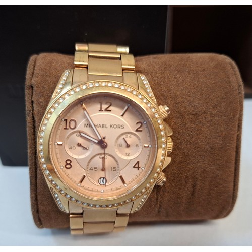 15 - Michael Kors- A ladies over-sized gold tone and white crystal watch with original watch box. Locatio... 