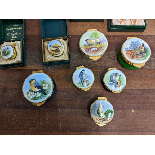 207 - A collection of Graham Payne hand painted and enamelled pill boxes of various sizes, decorated with ... 