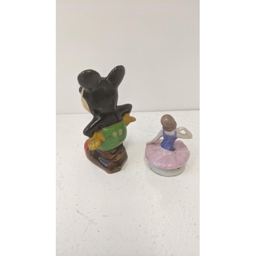 339 - A 1930's/40's pottery example of Mickey Mouse together with a porcelain half doll tea cosy
Location:... 