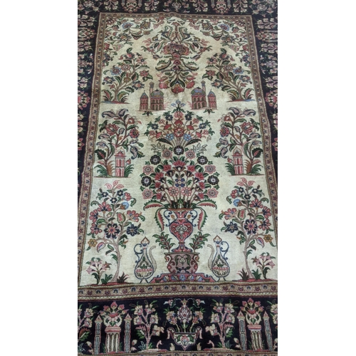 344 - A handwoven Persian Kashan rug having a cream  ground with black borders decorated with temples and ... 