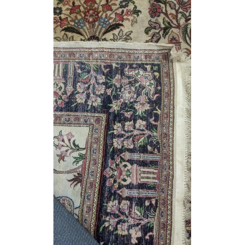 344 - A handwoven Persian Kashan rug having a cream  ground with black borders decorated with temples and ... 