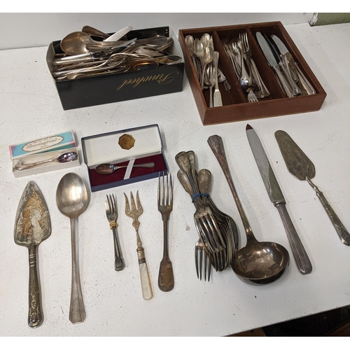 417 - A collection of silver plated flatware t include cake knives, cake forks, a mother of pearl handled ... 