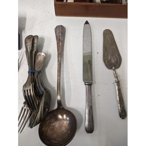 417 - A collection of silver plated flatware t include cake knives, cake forks, a mother of pearl handled ... 