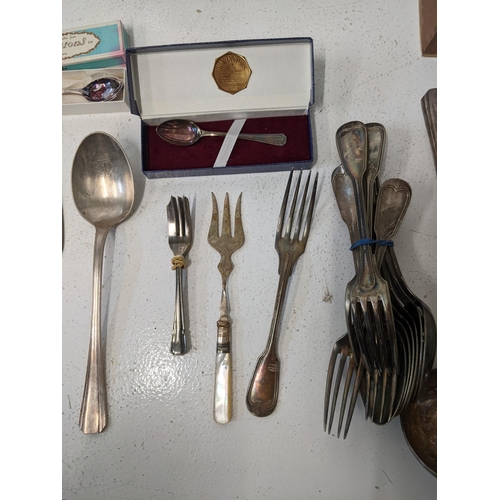 417 - A collection of silver plated flatware t include cake knives, cake forks, a mother of pearl handled ... 