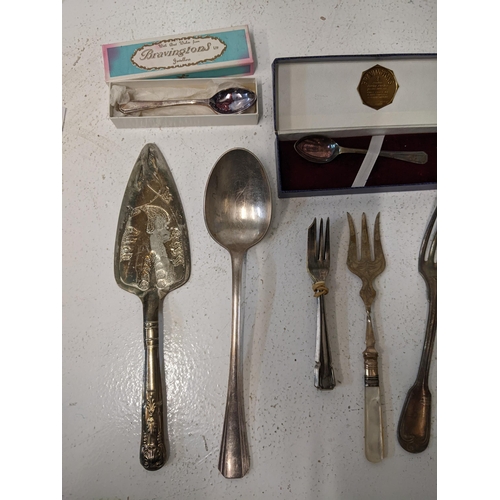 417 - A collection of silver plated flatware t include cake knives, cake forks, a mother of pearl handled ... 